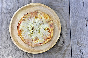 Homemade pizza or Italian Pizza in chopping board on a wooden table. top view, copy space