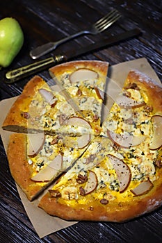 Homemade pizza with pear and walnuts. Dorblu pizza