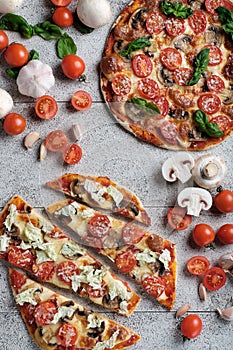 Homemade pizza with tomatoes, mushrooms and cheese
