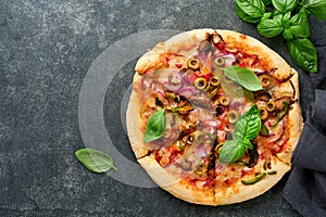 Homemade pizza. Traditional neapolitan pizza with olives, peppers, onions and mushrooms on wooden table backgrounds. Italian