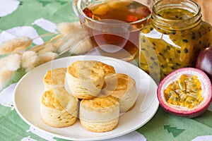 Homemade plain scones serve with homemade passion fruit jam. Scones is traditional English pastry for afternoon tea or coffee