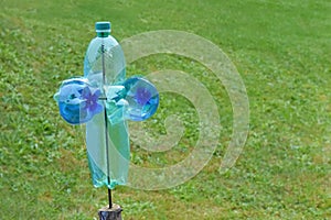 Homemade plastic bottle mill as a protection against harmful animals and birds on the garden