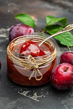 Homemade plum jam and fruits. vertical image. top view. place for text