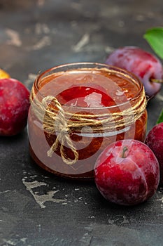 Homemade plum jam and fruits. vertical image. top view. place for text