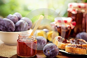 Homemade plum jam and plums on