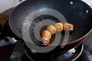 Homemade pork sausages fried in a pan