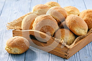 Homemade potato bread roll on wooden tray.