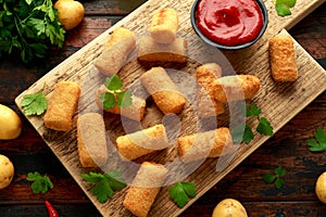 Homemade Potato Croquettes with dipping sauce on wooden board photo