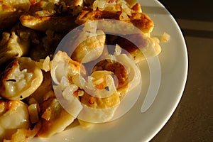 Homemade potato dumplings or vereniki pierogi, served with fried onions. Rustic style, comfort eastern europe cuisine