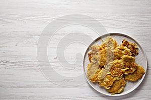 Homemade Potato Pancakes Latkes with Apple Sauce and Sour Cream on a white wooden table, top view. Flat lay, overhead, from above