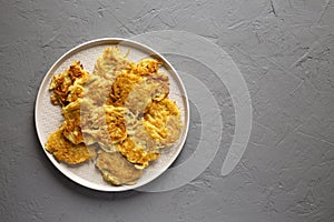 Homemade Potato Pancakes Latkes on a plate on a gray background, top view. Flat lay, overhead, from above. Space for text