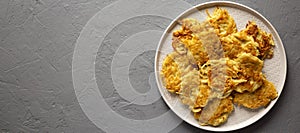 Homemade Potato Pancakes Latkes on a plate on a gray background, top view. Flat lay, overhead, from above. Space for text