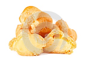 Homemade profiteroles with cream,isolated on a white background. Fresh baked golden profiterole. Custard cake photo