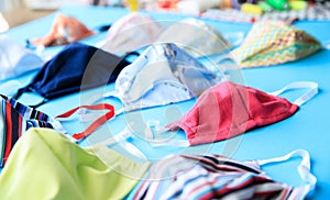 Homemade protection textil face, nose and mouth mask against virus . Sewing protective face masks at home during a covid-19 photo