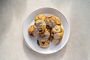 Homemade pumpkin cookies with dark chocolate in a plate