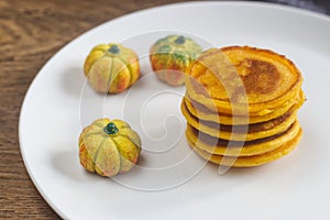 Homemade pumpkin pancakes on the white plate