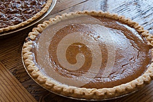 A Homemade pumpkin pie on old painted wood table