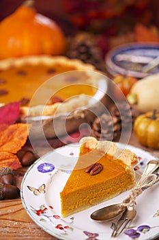 Homemade pumpkin pie on a rustic table with autumn decorations