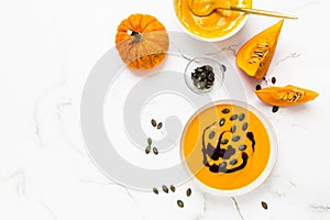 Homemade pumpkin soup with pumpkin oil and seeds