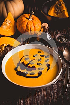 Homemade pumpkin soup with pumpkin oil and seeds