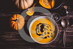 Homemade pumpkin soup with pumpkin oil and seeds