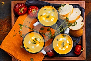 Homemade pumpkin soup in retro enamel mugs