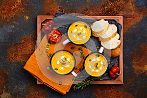 Homemade pumpkin soup in retro enamel mugs