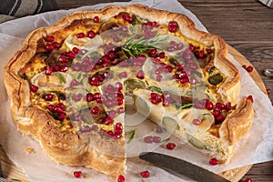 Homemade quiche with vegetables, brussels spouts, goat cheese and pomegranate. Vegetarian food. French cuisine