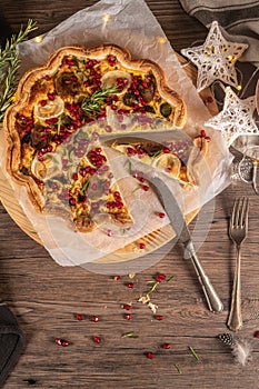 Homemade quiche with vegetables, brussels spouts, goat cheese and pomegranate. Vegetarian food. French cuisine.