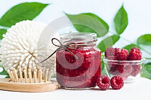 Homemade raspberry face and hair mask/scrub in a glass jar. DIY cosmetics and spa.