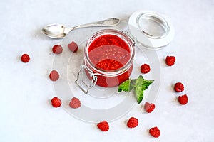 Homemade raspberry jam in jar with raspberries and mint. diet, organic clean eating. top view
