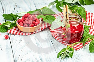 Homemade raspberry jam in jar with raspberries and mint. Long banner format. place for text