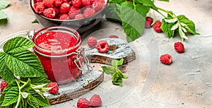 Homemade raspberry jam in jar with raspberries and mint. Long banner format. place for text