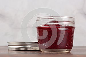 Homemade raspberry jam in a reusable glass jar