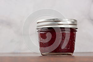Homemade raspberry jam in a reusable glass jar