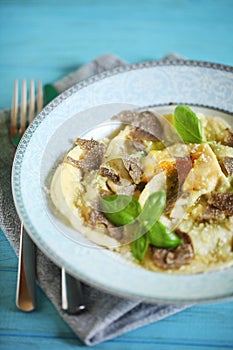 Homemade ravioli stuffed with egg yolk, ricotta and black truffles