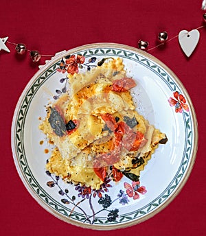 Homemade ravioli with tomatoes and sage