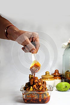 Homemade raw mango pickle prepared in India during summer season