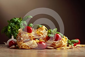 Homemade raw pasta with tomato, garlic, and basil