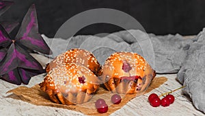 Homemade red currant muffins with sesame seeds. Closeup. Copy space