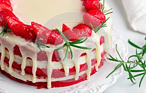 Homemade red velvet cake with white chocolate, fresh strawberries and rosemary
