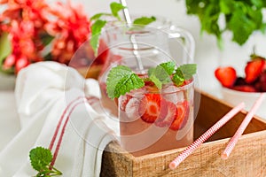 Homemade refreshing strawberry lemonade in pitcher and glass