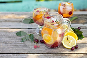 Homemade refreshing wine sangria or punch with fruits in glasses. Sangria cocktails with fresh fruits, berries and rosemary.