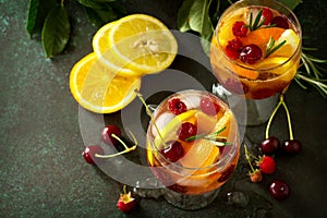 Homemade refreshing wine sangria or punch with fruits. Sangria cocktails with fresh fruits, berries and rosemary.