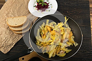 Homemade Roasted Potato in a Frying Pan on Rustic Background