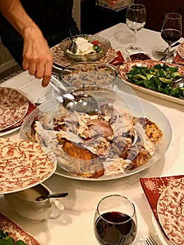 Homemade Roasted Thanksgiving Day Turkey with all the Sides at Dinner Table.