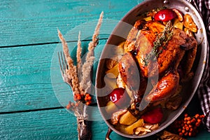 Homemade Roasted Thanksgiving Day Turkey on bright blue wooden background.