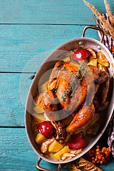 Homemade Roasted Thanksgiving Day Turkey on bright blue wooden background.