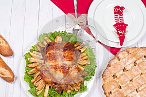 Homemade roasted whole turkey on wooden table for Thanksgiving.