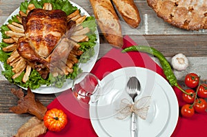 Homemade roasted whole turkey on wooden table for Thanksgiving.